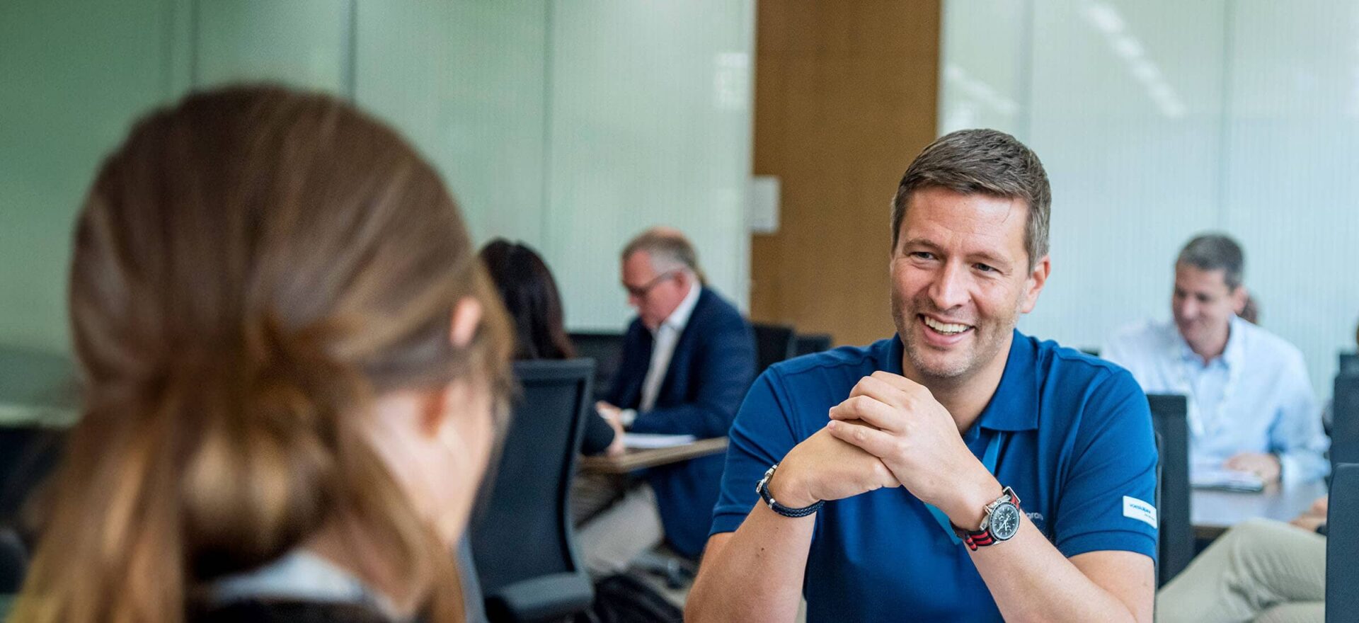 Executive Master in Sustainable Business Transformation – Hero Image- medium - IMD Business School Group of business professionals in discussion during a sustainability-focused executive education program at IMD - IMD Business School