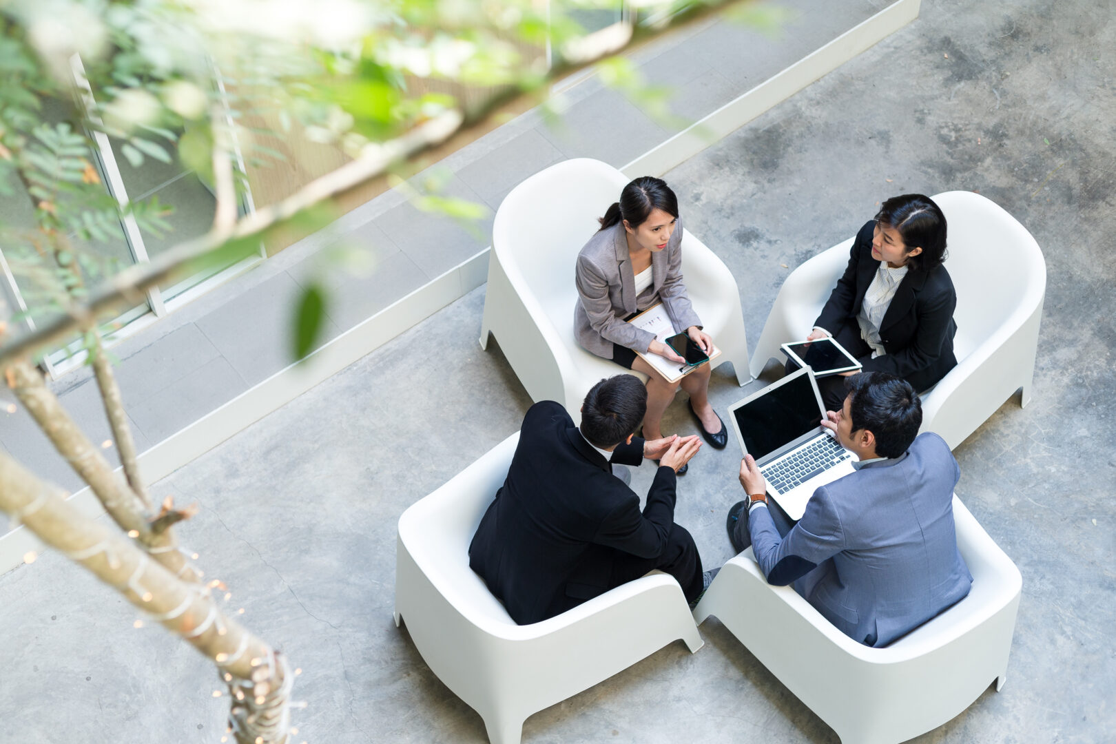 Top view of business people having discussion together - Asia page - IMD Business School - IMD Business School